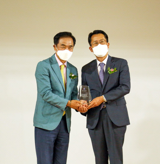 윤재업(오른쪽) KCC 상무이 지난 23일 경기도 평택시 복창초등학교에서 개최된 '2020년형 민관협력형 노후주택개선 지원사업 준공식'에서 정장선 평택시장에게 감사패를 수여받고 기념사진을 촬영하고 있다. <KCC 제공>